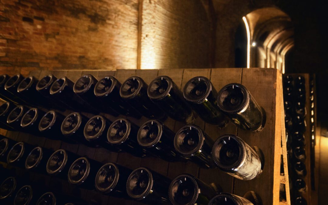 Pupitre and bottles inside an underground cellar for the production of traditional method sparkling wines in italy