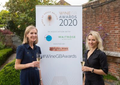 Two women in Front of Award banner